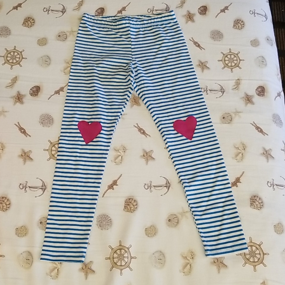 A pair of striped leggings with hearts on the knee
